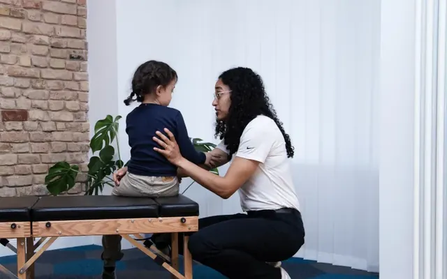 Chiropractor with a small child